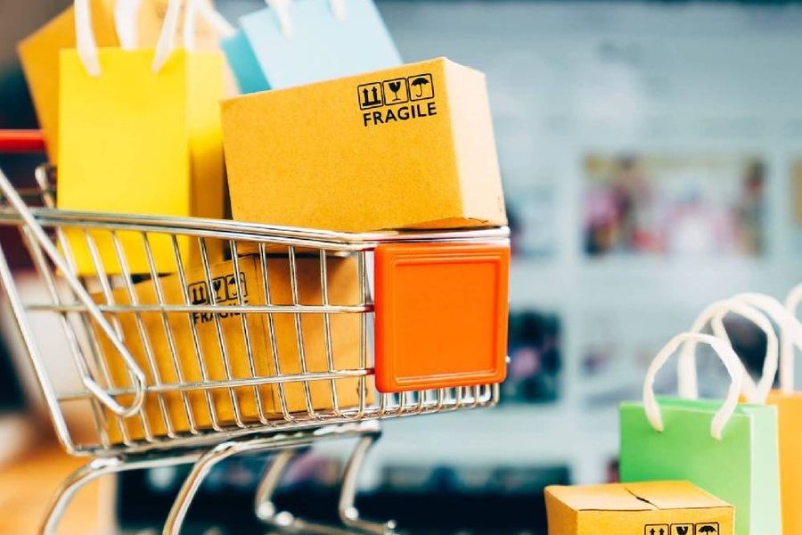 A shopping cart full of gift bags and boxes